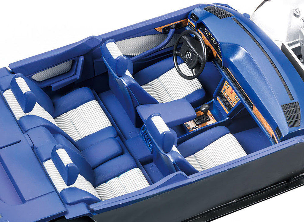 Close-up of a blue car interior with steering wheel and dashboard.