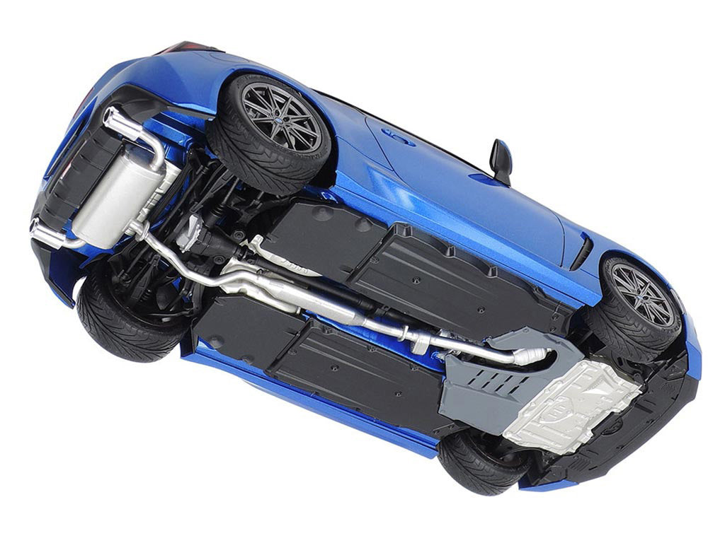 Blue toy car on its side with visible internal components on a white background