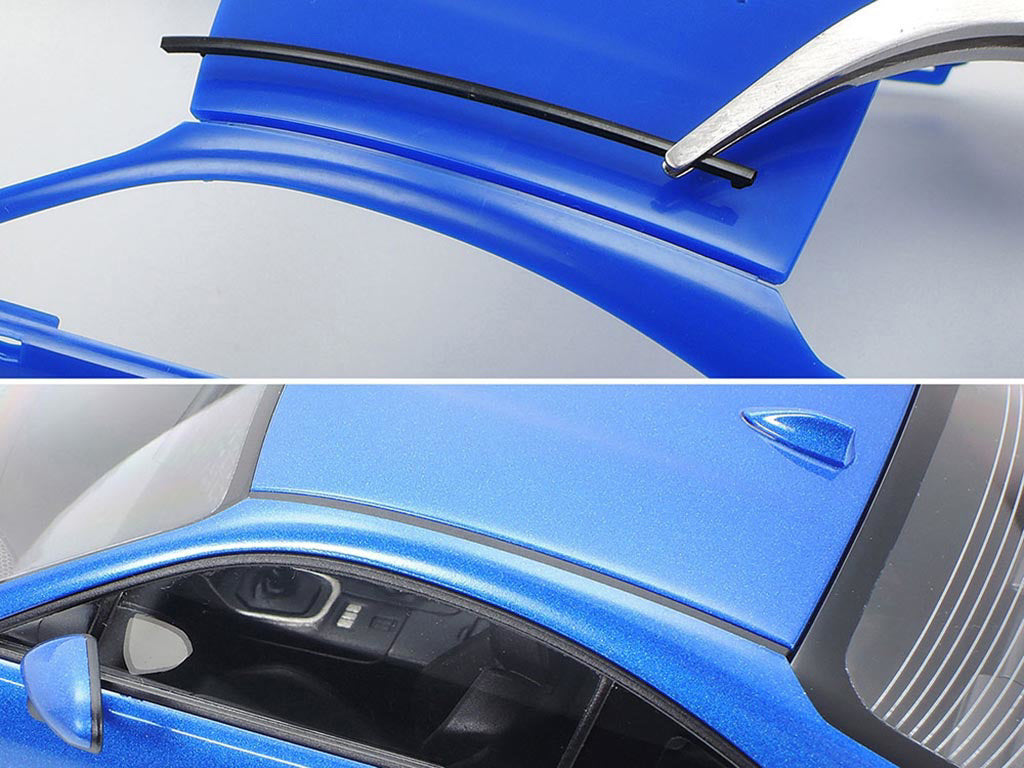 Close-up of a blue car's roof with a wiper blade and a detailed view of the car's surface.