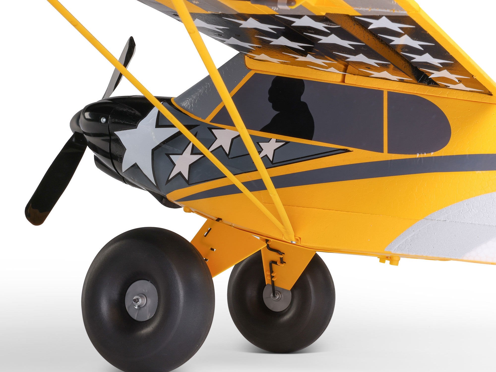 Carbon Cub S 2 Cleetus McFarland RC airplane side view showcasing detailed design and durable wheels.