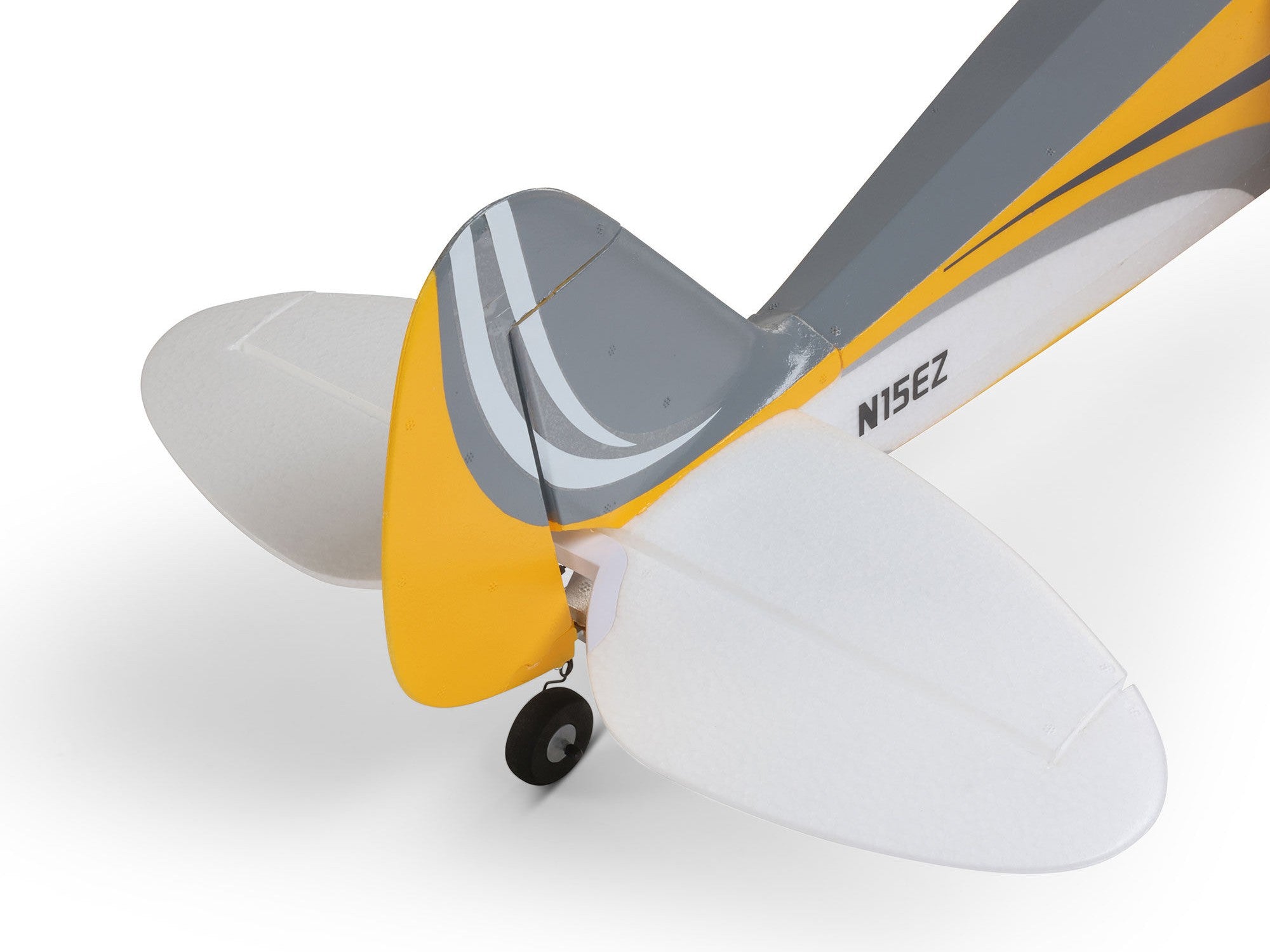 Carbon Cub S 2 Cleetus McFarland RC airplane rear view showing grey-yellow tail design and landing gear.