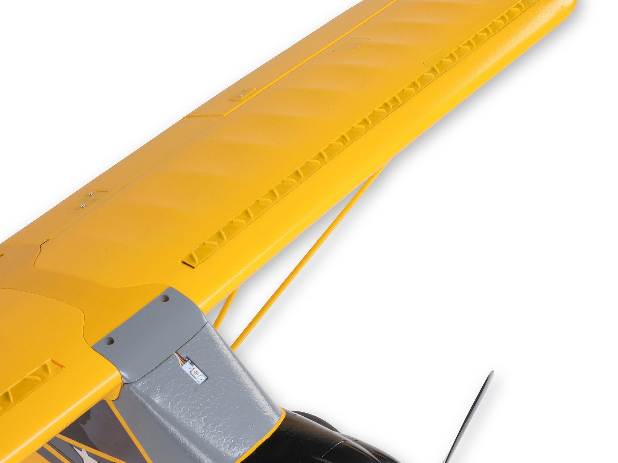 Top view of the wing of the Carbon Cub S 2 Cleetus McFarland RC airplane with a vibrant yellow finish.