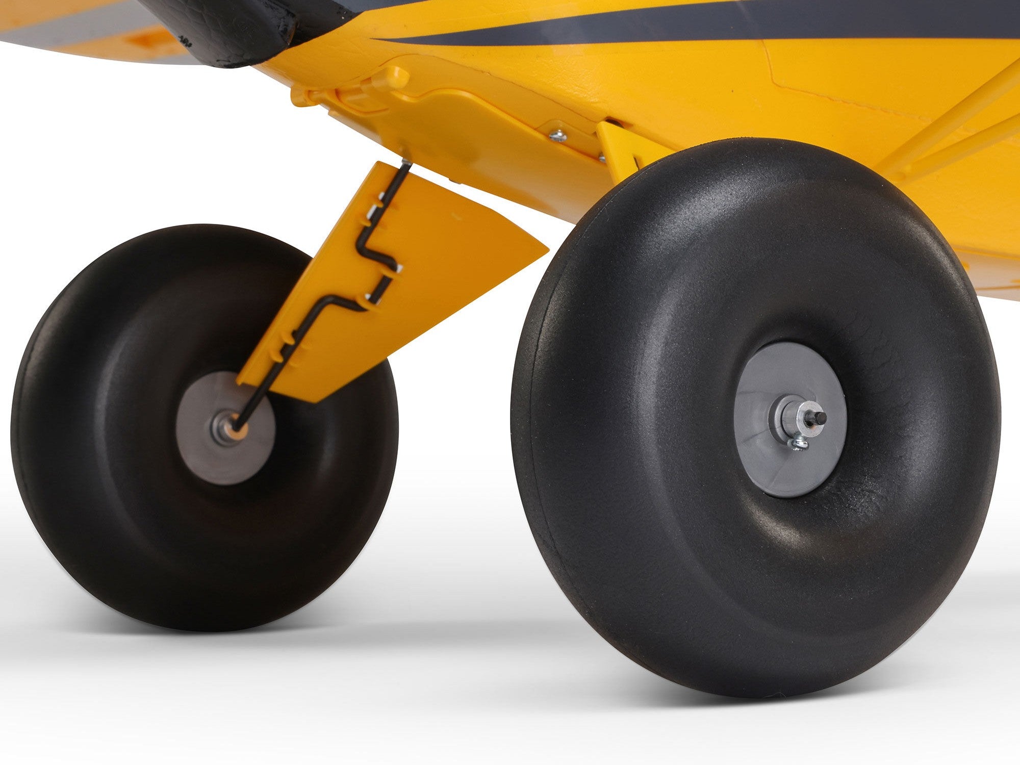 Close-up view of landing gear and wheels of Carbon Cub S 2 Cleetus McFarland RC airplane.