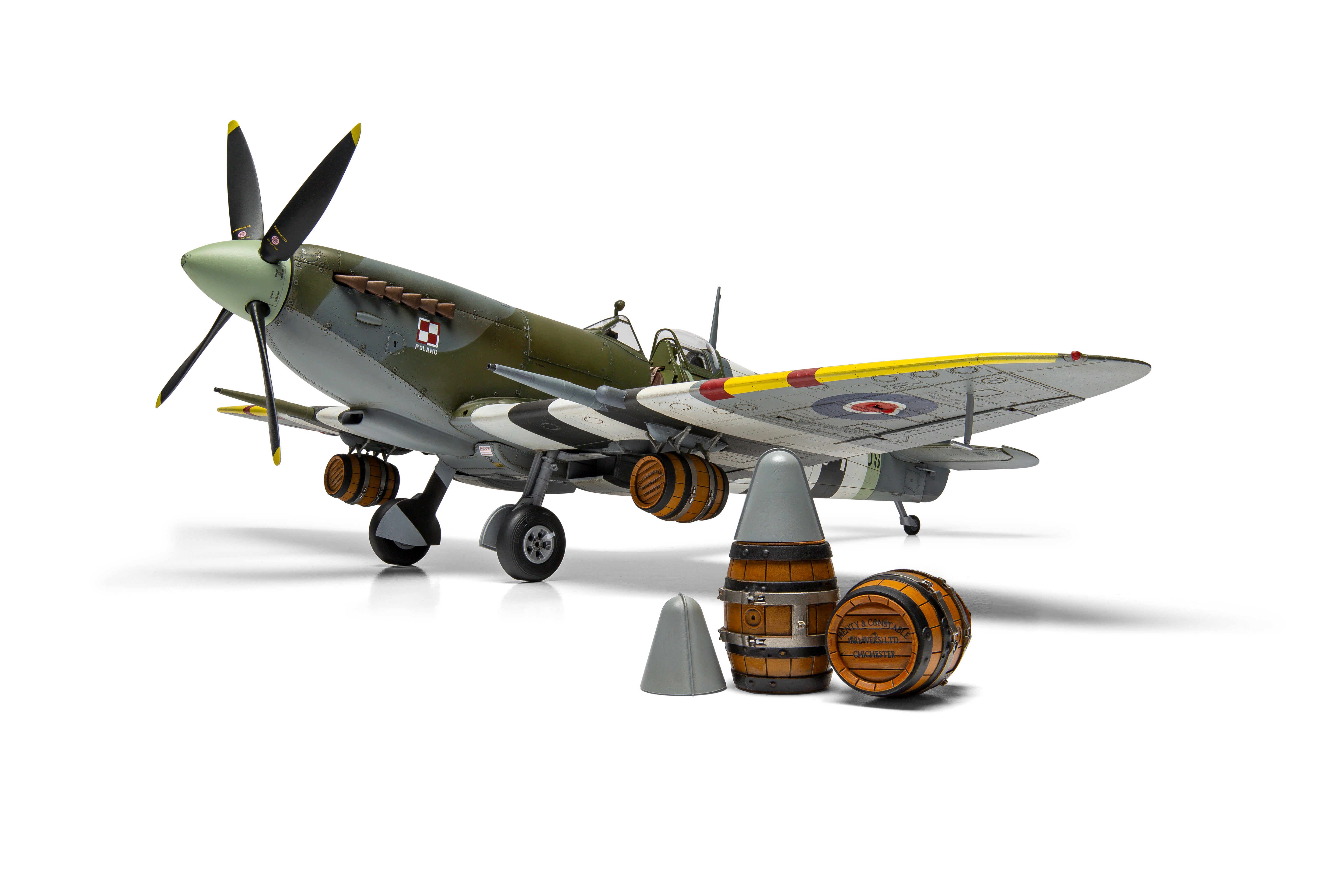Model of a vintage airplane with barrel bombs on a white background