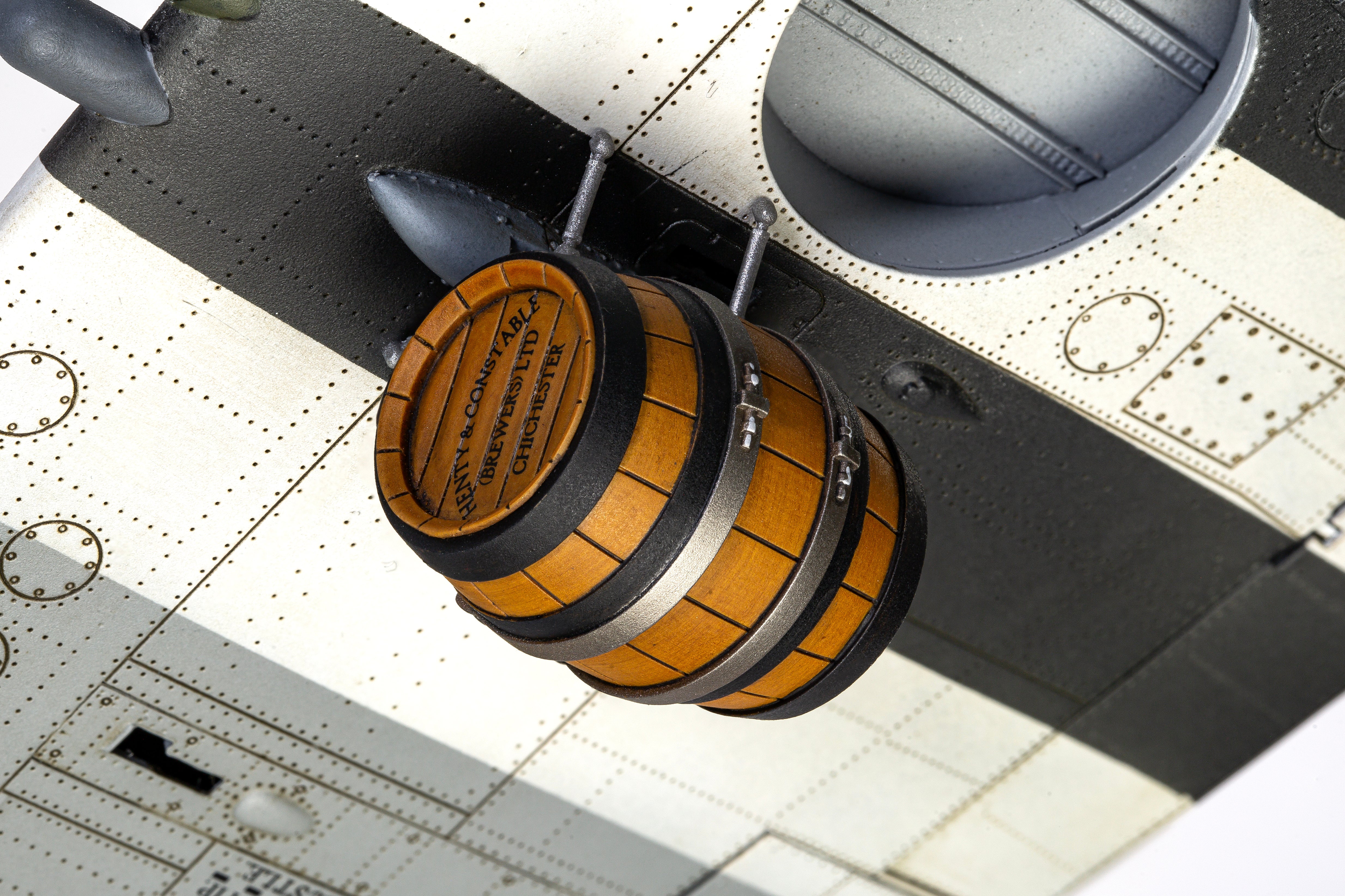 Model airplane with a barrel bomb attached on a detailed background