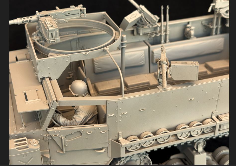 Detailed view of 1/16 scale M3 M3A1 Halftrack model kit from Andy's Hobby with driver figure and intricate components.