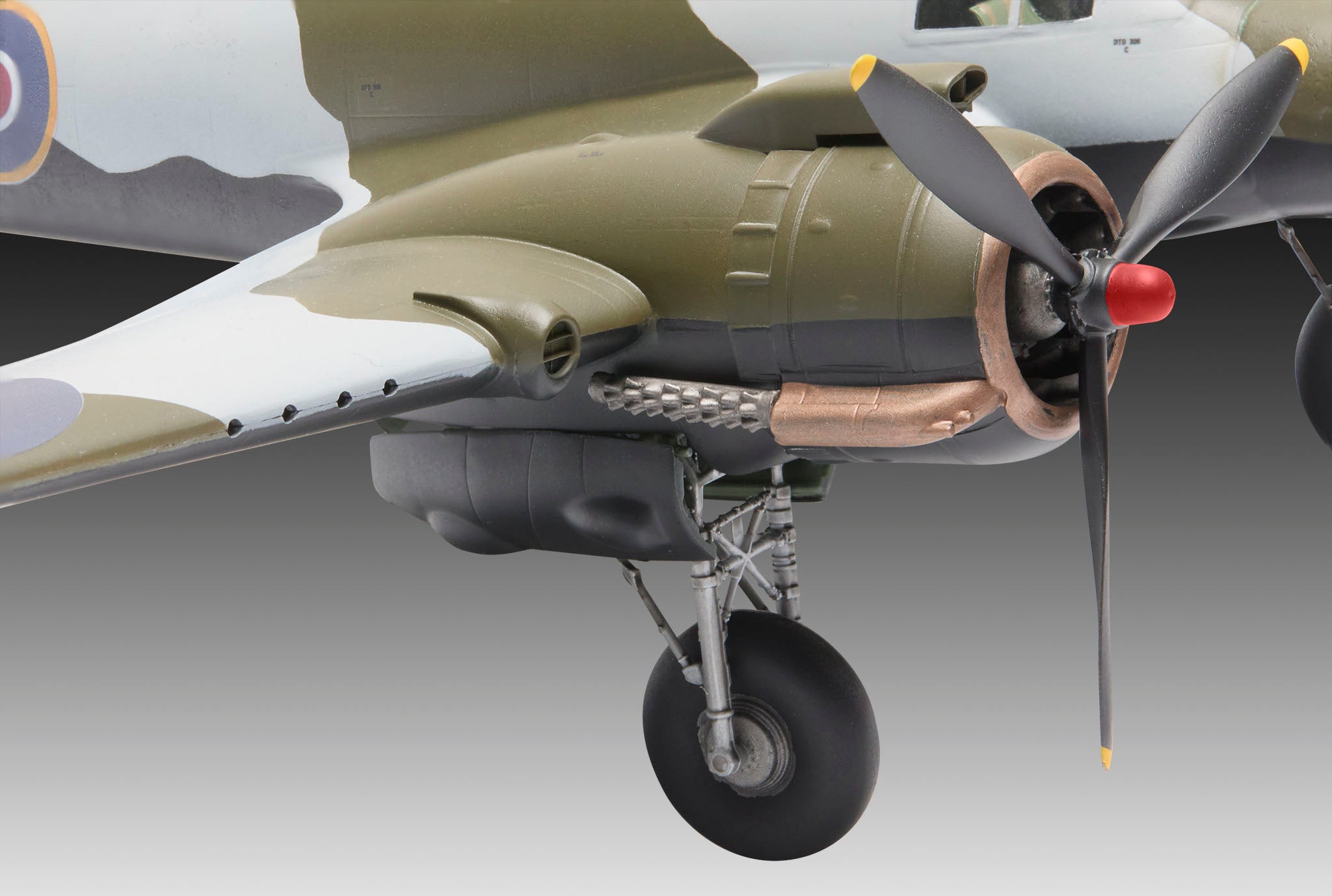 Close-up of a military aircraft with a propeller on a gray background