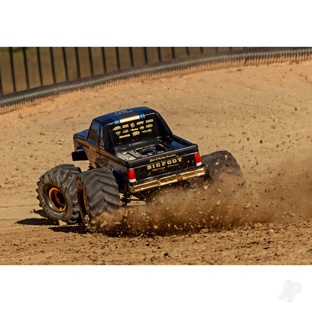 Model truck racing on a dirt track with a blurred background