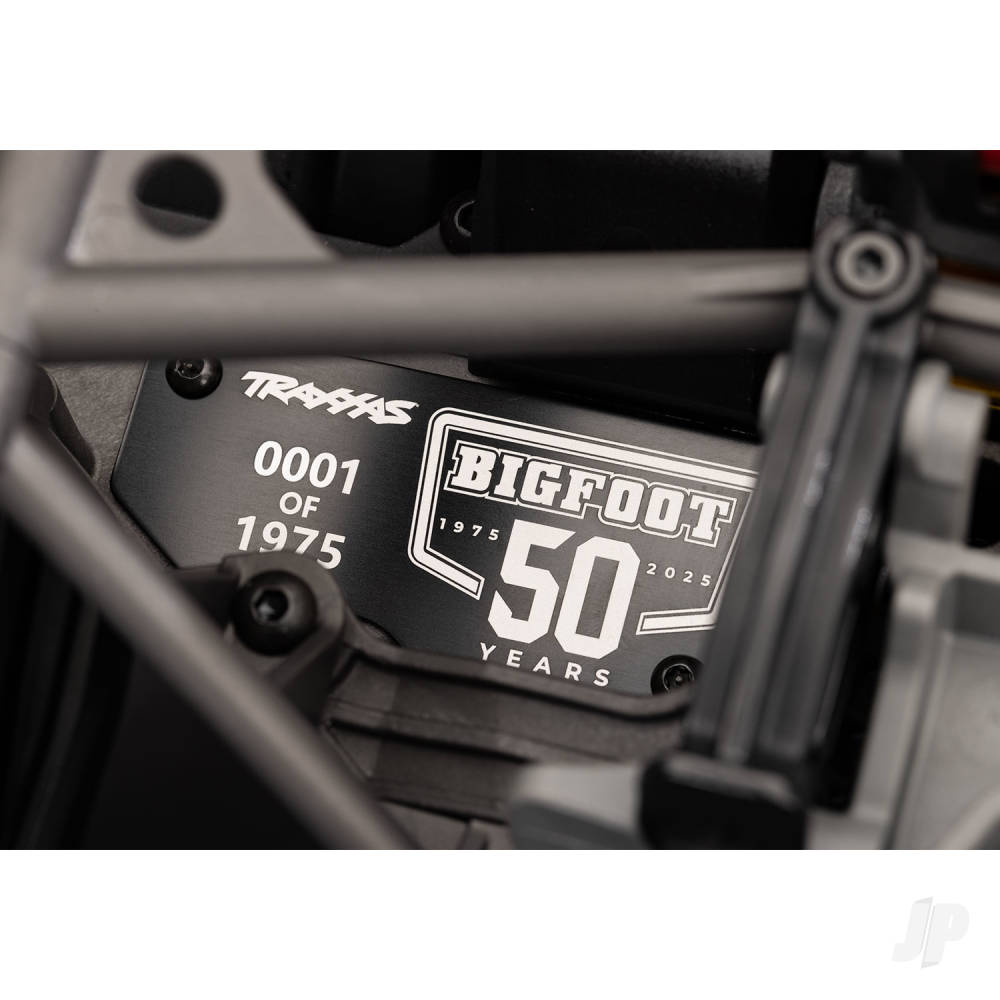 Close-up of a mechanical component with 'Bigfoot 50 Years' and 'Travis' branding.