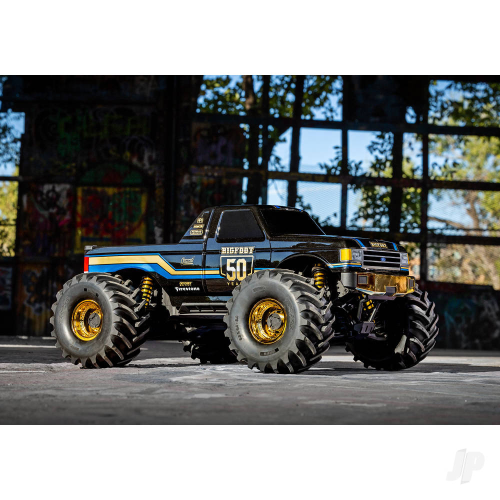Monster truck with large wheels and a detailed design in an outdoor setting.