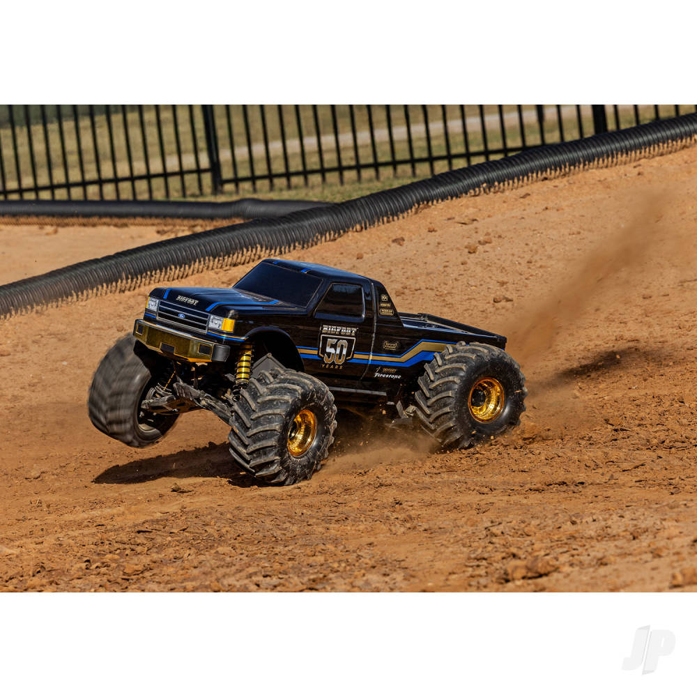 Monster truck on a dirt track with a white background