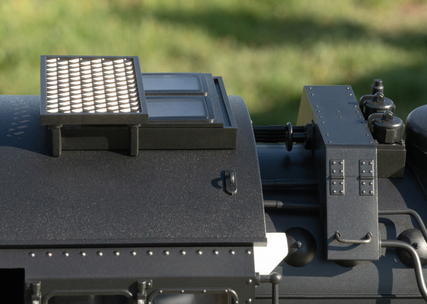 Close-up of a mechanical component with a filter on a blurred green background