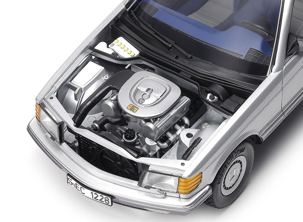 Car engine compartment with Mercedes-Benz logo on a white background