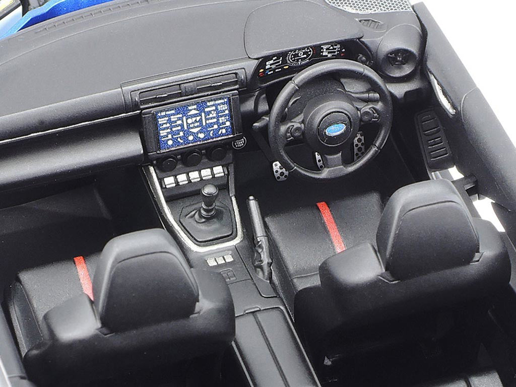 Car interior with dashboard, steering wheel, and seats.