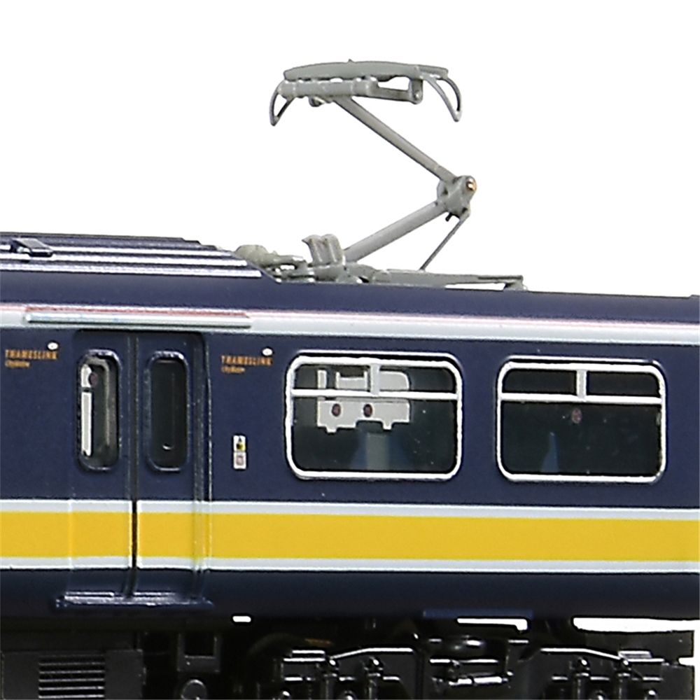 Close-up of a blue and yellow train with electrical components on a white background