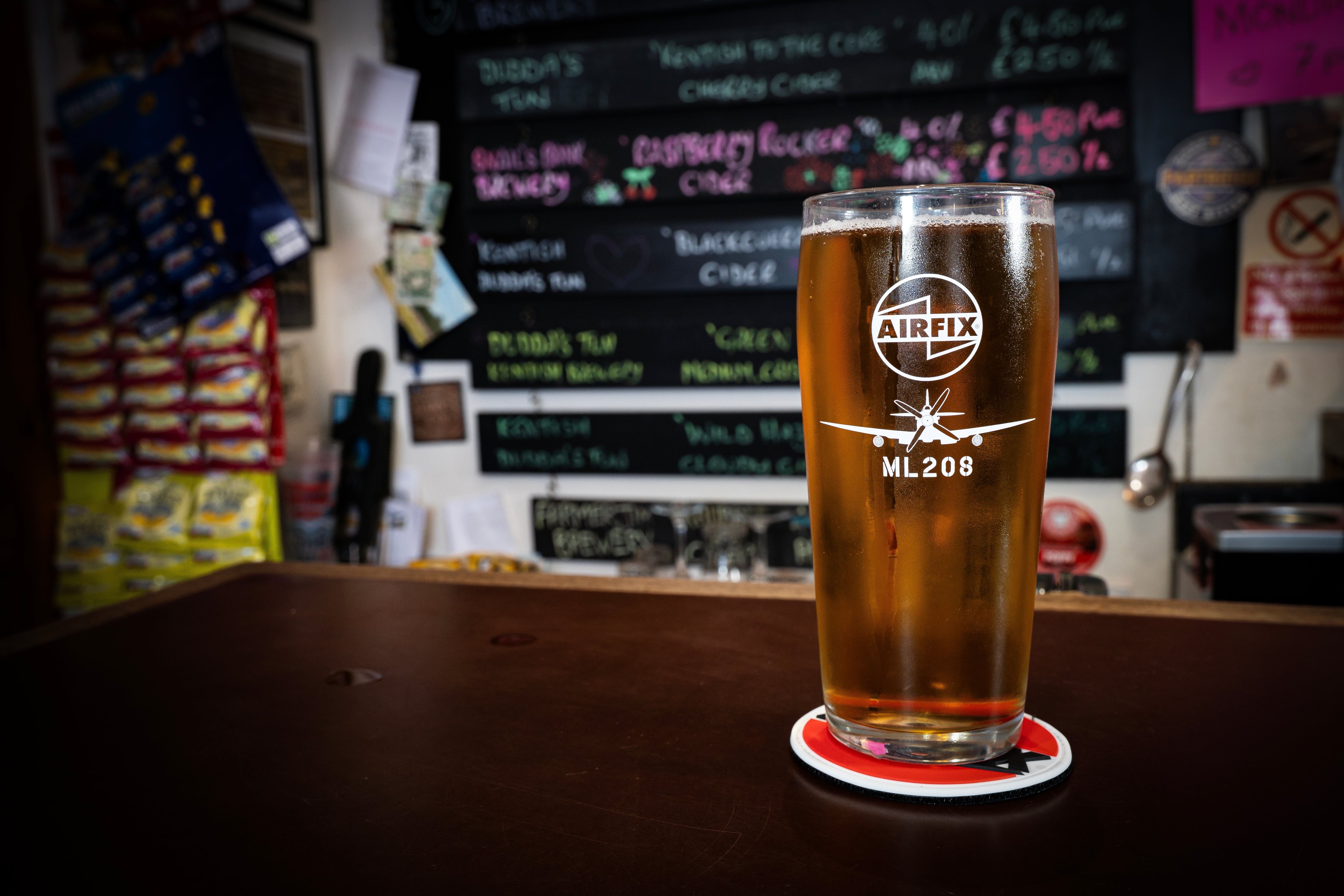 Pint of beer with Airfix logo on a coaster in a pub setting