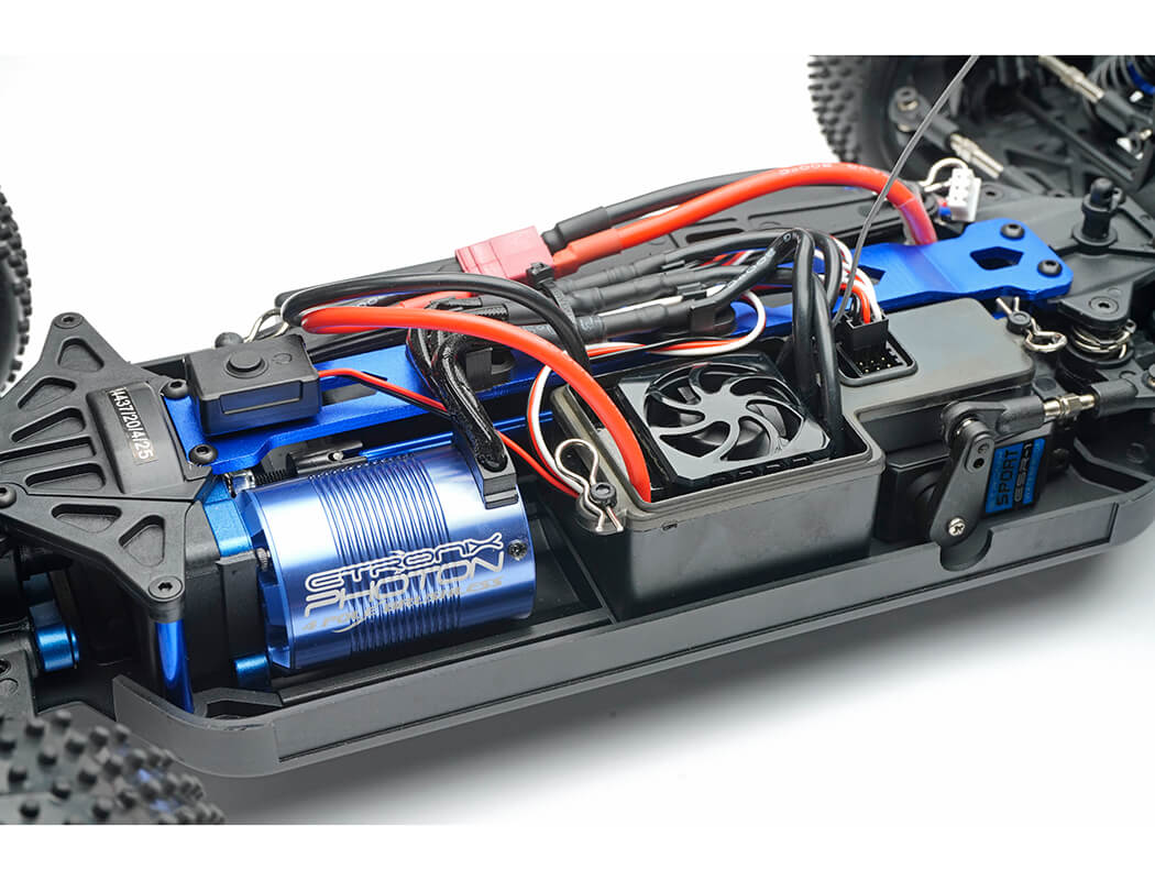 Close-up of a detailed RC car chassis with visible components on a white background
