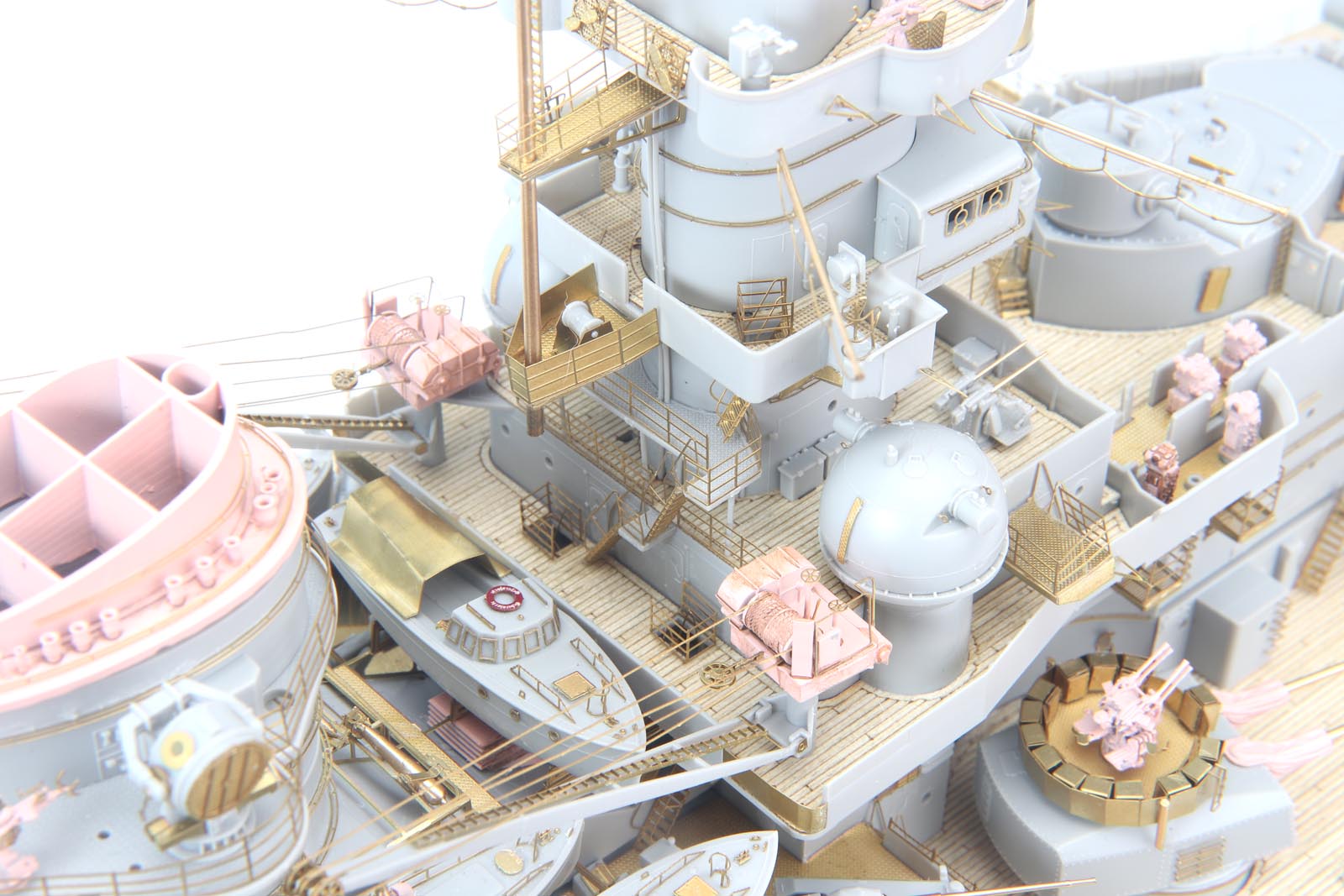 Close-up of DKM Scharnhorst model kit featuring detailed brass parts and wooden deck, perfect for enthusiasts.