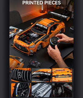 CaDa Mercedes-AMG GT3 model showcasing detailed printed pieces and striking orange color on a table.