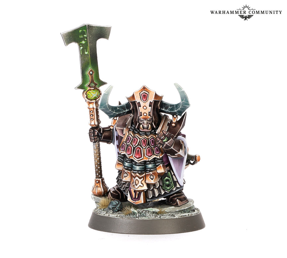 Warhammer figurine with armor and axe on a white background
