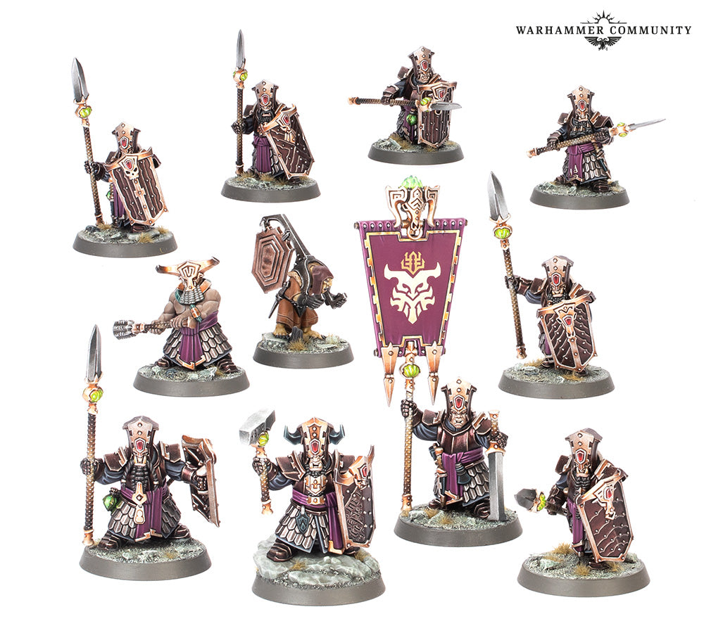 Collection of Warhammer figurines with various weapons and armor on a white background.